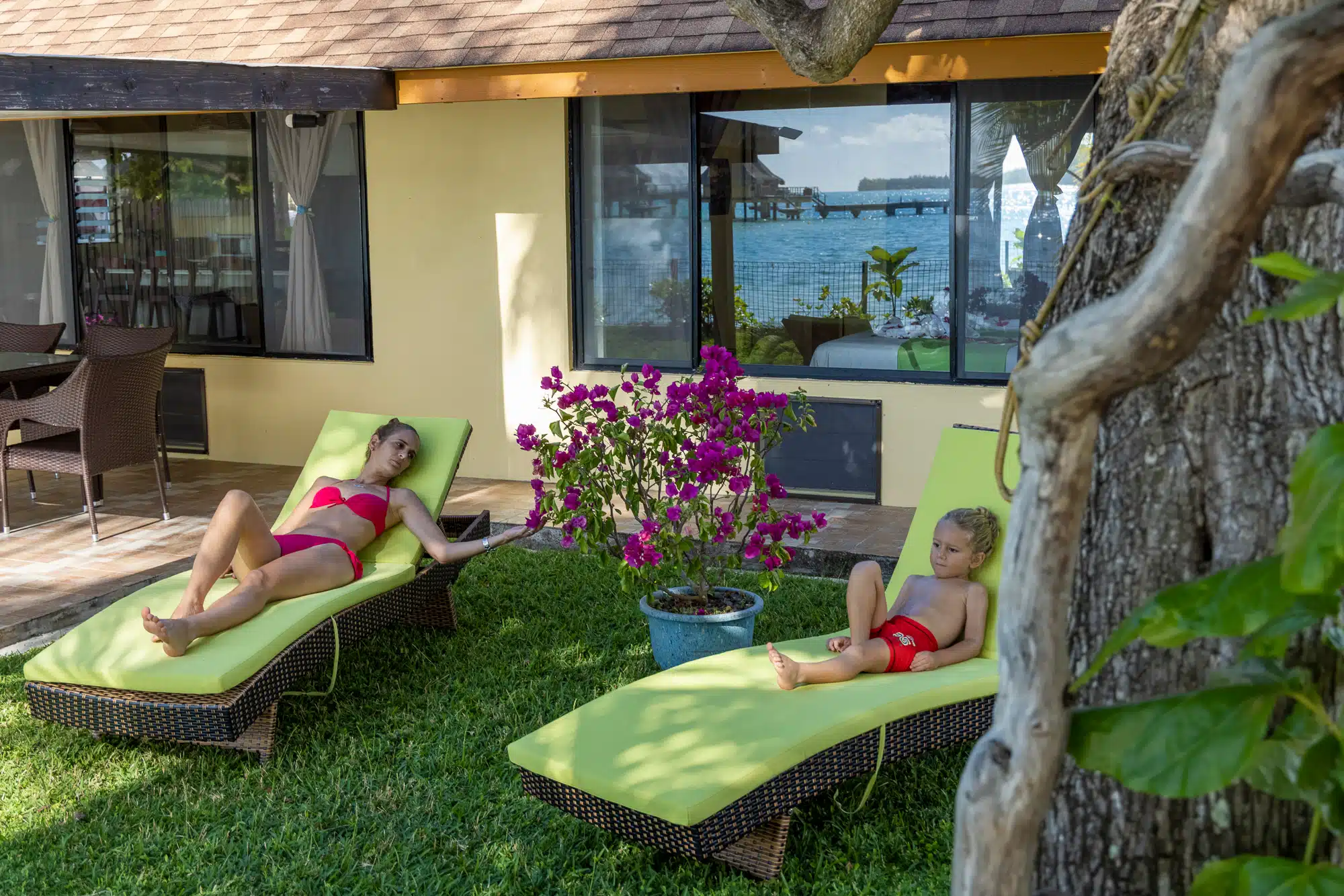 Loungers on the patio at Fare Manava with a lagoon view
