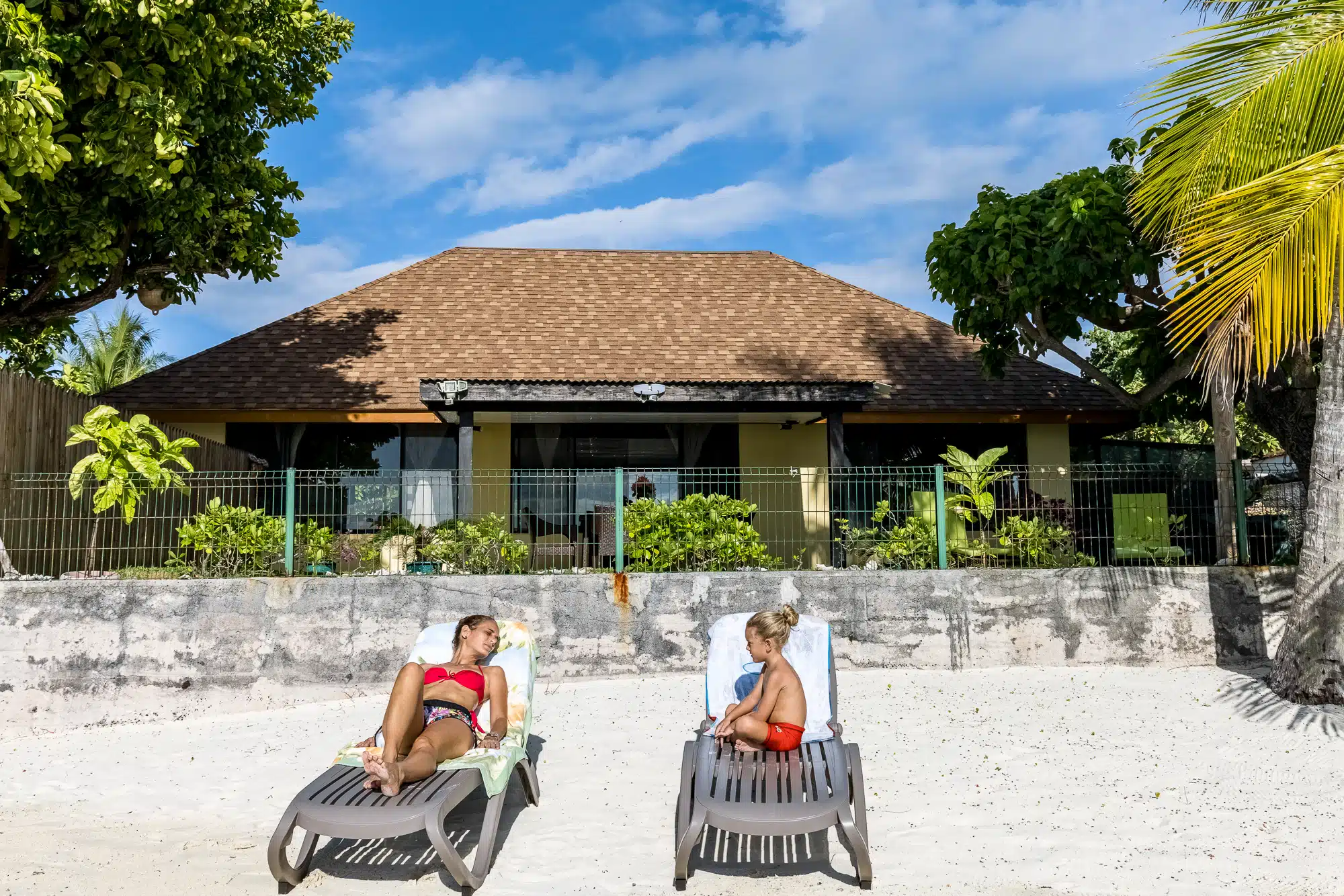 Close-up of beach loungers on Matira Beach in front of Fare Manava