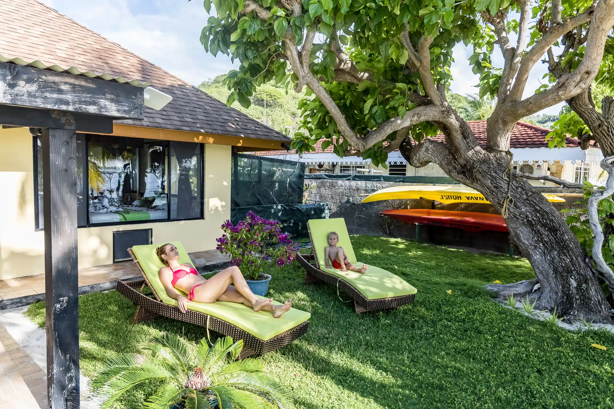 Garden loungers and kayaks at Fare Manava