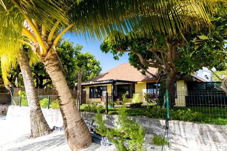 Fare Manava beachfront exterior with palm trees on Matira Beach, Bora Bora